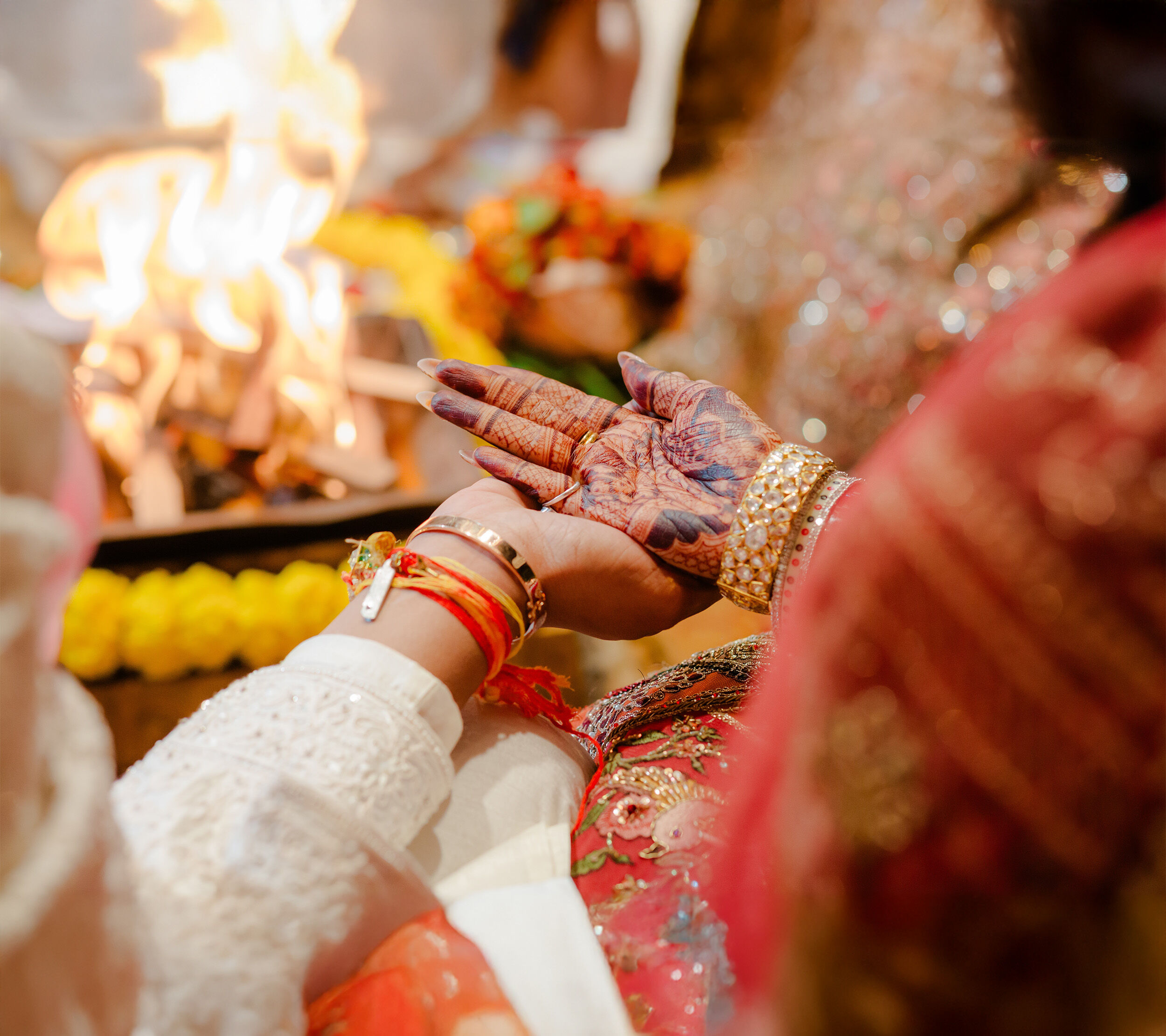 A groom holding brides hand doing indian wedding ritual
